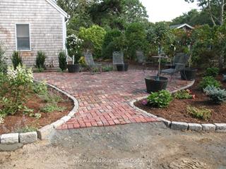 Antique brick paver patio and cobble stone edged driveway installation in Harwich