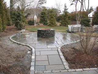 Bluestone patio with fire pit construction.