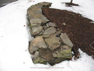 Damaged stone wall repaired in Brewster after being hit by truck backing up.