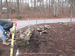 Damaged stone wall repaired in Brewster after being hit by truck backing up.