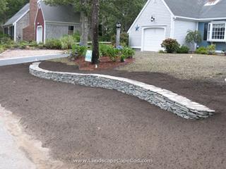 Curved flat stone wall and lawn renovation in Yarmouth Port