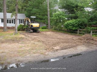 New driveway, lawn renovation and replacement of old brick patio with a new Belgard paver patio installation.